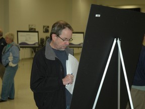 An Eastwood subdivision resident reviews a display at a public information centre April 7, 2014 at Memorial Arena in St. Thomas. (File photo)