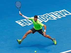 Milos Raonic hits a return to Illya Marchenko during their men's singles first round match at the Australian Open in Melbourne on Tuesday, Jan. 20, 2015. (Thomas Peter/Reuters)
