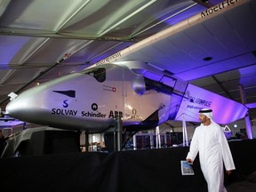A man walks past the Solar Impulse 2 during its presentation at the Al Bateen airport in Abu Dhabi on Jan. 20, 2015. Solar Impulse 2, a plane powered by the sun, will attempt an unprecedented flight around the world next month, the project's founders said, seeking to prove that flying is possible without using fossil fuel. (REUTERS/Ahmed Jadallah)
