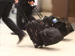 Travellers walk throughout the International Arrivals area at the Calgary International Airport in Calgary, Alta on Thursday October 9, 2014. Jim Wells/Calgary Sun/QMI Agency