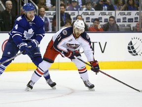 Columbus Blue Jackets left winger Nick Foligno (71) prepares to shoot as Toronto Maple Leafs defenceman Cody Franson (4) guards him at Air Canada Centre on Jan. 9.