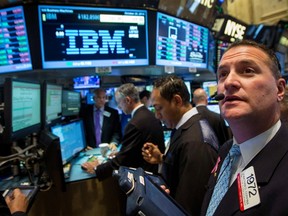 Traders gather at the post that trades IBM on the floor of the New York Stock Exchange, in this file photo taken Oct. 20, 2014.  REUTERS/Brendan McDermid/Files