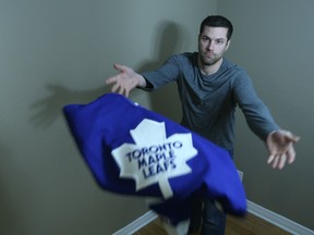 Alain Lind of Barrhaven throws his one and only Toronto Maple Leafs jersey toward the camera Tuesday, Jan. 21, 2015. Lind is contemplating throwing the sweater at the Maple Leafs bench during Wednesday night's Sens-Leafs game at the Canadian Tire Centre. (Doug Hempstead/Ottawa Sun)