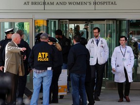 Local, state and federal law enforcement officials gather outside the building where a shooting occurred at Brigham and Women's hospital in Boston, Jan. 20, 2015. (BRIAN SNYDER/Reuters)
