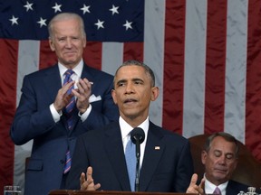 U.S. President Barack Obama (C) delivers his State of the Union address to a joint session of Congress, as Vice President Joe Biden (L) applauds and House Speaker John Boehner (R-OH) listens on Capitol Hill in Washington, January 20, 2015. REUTERS/Mandel Ngan/Pool