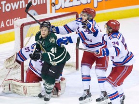 Rangers defenceman Max Iafrate gets away with a cross check on London Knights forward Matt Rupert in front of Kitchener goalie Jake Paterson during the second period of their OHL game at Budweiser Gardens on Tuesday night. Rupert scored in overtime for a 3-2 win. (DEREK RUTTAN, The London Free Press)