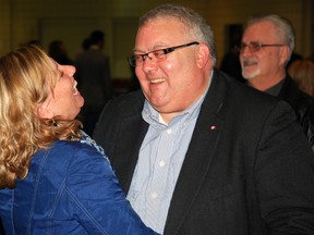 Karen Vecchio, left, shares a laugh with Elgin-Middlesex-London MP Joe Preston at St. Joseph's Catholic High School in St. Thomas, Ont. on Saturday. Vecchio is Preston's long-time assistant and had just learned she will succeed him as the riding's federal Conservative nominee.