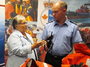Sarnia-Lambton MP Pat Davidson speaks Wednesday with Jamie Kerwin, with the Canadian Coast Guard Auxiliary, about some of the equipment its volunteers use, following an event held in Sarnia to promote the contributions made by the auxiliary. (PAUL MORDEN, The Observer)