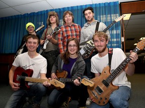Students involved in the Limestone District School Board Guitar Building focus program show off their work at Kingston Collegiate with teacher Gary Pattenden, middle, rear. Front, from left, Nick Streicher, Jess Wannamaker and Taylor Cunningham. Rear, from left, Stuart-Miller Davis, Connor Davies and Ben Garofalo. (Ian MacAlpine/The Whig-Standard)