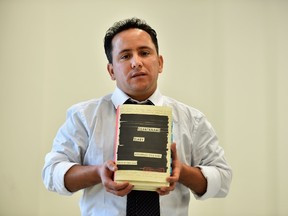 Yahdih Ould Slahi, the younger brother of Mohamedou Ould Slahi, poses with a copy of Mohamedou's prison memoir 'Guantanamo Diary' during an event in London on January 20, 2015. The family and supporters of "one of the most abused prisoners in Guantanamo" on January 20 launched a new celebrity-backed campaign demanding his release, coinciding with the publication of his prison diary. Mohamedou Ould Slahi was detained in his home country of Mauritania following the September 11 attacks on the United States in 2001, on suspicion of involvement in an unsuccessful plot to bomb Los Angeles in 1999, and was taken to Guantanamo in 2002. US district court judge James Robertson ordered that Slahi be released in 2010 due to lack of evidence that he was directly involved in al-Qaeda terror plots, but he remains in detention after the Department of Justice appealed the decision. Human rights activist Larry Siems, the book's editor, Slahi's lawyer Nancy Hollander and brother Yahdih described the battle to release the memoirs and his current legal limbo during a press conference in London. AFP PHOTO / BEN STANSALL