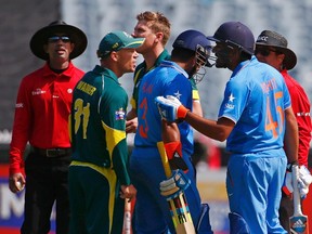 Aussie David Warner and India's Rohit Sharma exchange pleasantries last week in Melbourne. (Reuters)