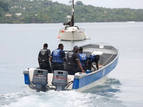 Members of Jamaica's Marine Police leave the port to join in the search for a small U.S. private plane with an unresponsive pilot that crashed off the east coast of Jamaica, in Port Antonio September 6, 2014. The plane veered far off its course toward southwest Florida and triggered a U.S. security alert that prompted a fighter jet escort. A New York county official said that Larry Glazer, a real-estate executive from Rochester in New York, and his wife, Jane Glazer, were aboard the plane and that both were killed. REUTERS/Gilbert Bellamy