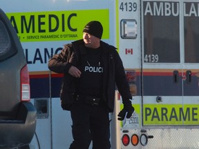 A police officer surveys the area outside the Chimo Hotel in Ottawa Jan. 21, 2015. Ottawa police said one man was arrested "without incident" on Wednesday after the hotel was evacuated overnight and hazardous materials and explosives teams deployed to the site.    (REUTERS/Blair Gable)