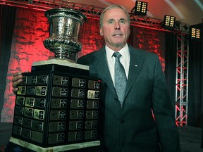 Stampeders GM/head coach John Hufnagel poses with the Annis Stukus Trophy as 2014 CFL coach of the year in Winnipeg on Wednesday, Jan. 21, 2015. (Kevin King/QMI Agency)