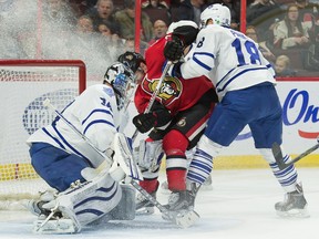 Maple Leafs goalie James Reimer  makes a save on Senators centre Curtis Lazar in Ottawa on Wednesday night. (USA Today Sports)