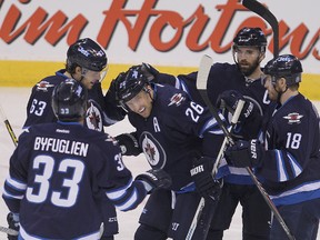 Blake Wheeler & his Jets teammates celebrate his first-period goal on Wednesday. (BRIAN DONOGH/Winnipeg Sun)