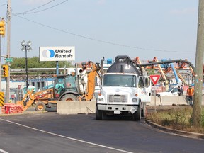 Crews are shown in this file photo at work on a Sun-Canadian pipeline at the corner of Vidal Street and Churchill Road in Sarnia that ruptured in September 2013 spilling approximately 35,000 litres of diesel fuel. The province has decided not to lay environmental charges against the pipeline company. (File photo)