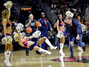 Actor Will Ferrell hits an actress playing a member of the New Orleans Pelicans dance team in the face with a ball during a stunt filmed for the movie Daddy's Home that filmed at halftime of a game against the Los Angeles Lakers at the Smoothie King Center. (Derick E. Hingle-USA TODAY Sports)