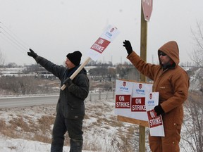 Brothers Greg and Darren Pinter man the picket lines outside the main gate of Carmeuse Lime and Stone in Beachville, Ont., on Wednesday, Jan. 21, 2015. (MEGAN STACEY, Sentinel-Review)