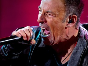 Bruce Springsteen performs with U2 during a surprise concert in support of World AIDS Day in Times Square in New York, December 1, 2014.  REUTERS/Carlo Allegri