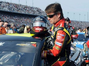 Jeff Gordon climbs into his Chevrolet at the Daytona International Speedway in Daytona Beach, Florida February 21, 2013. (REUTERS/Brian Blanco)