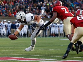Tyler Varga of the Yale Bulldogs reaches for a touchdown as Norman Hayes of the Harvard Crimson closes in during a game November 22, 2014 in Boston, Mass. (Jared Wickerham/Getty Images/AFP)