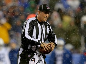 Umpire Carl Paganelli #124 holds a ball on the field after a play during the 2015 AFC Championship Game between the New England Patriots and the Indianapolis Colts at Gillette Stadium on January 18, 2015 in Foxboro, Massachusetts. (Elsa/Getty Images/AFP)