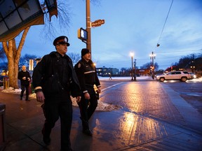 Cst. Joe Allan (left) and Cst. Dan Fedechko patrol along Whyte Avenue during the start of a Community Action Team (CAT) deployment in the area in Edmonton, Alta., on Wednesday, Dec. 10, 2014. The deployment runs from Dec. 10-14 and it concentrates on violence reduction in the area leading up to the holidays. Ian Kucerak/Edmonton Sun