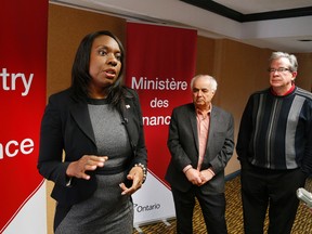 Associate Minister of Finance Mitzie Hunter talks to reporters as Peterborough MPP Jeff Leal and Northumberland-Quinte West MPP Lou Rinaldi look on ahead of a consultation on the Ontario Retirement Pension Plan (ORPP) held at the Holiday Inn in Peterborough on Thursday, Jan. 22, 2015. Clifford Skarstedt/Peterborough Examiner/QMI Agency