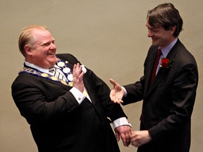 Rob Ford jokes with Councillor Gord Perks as Ford is officially handed the Chain of Office as mayor Dec. 7, 2010. (Dave Abel/Toronto Sun files)