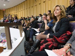 Executive director of Pillar Nonprofit Network Michelle Baldwin sits in the public gallery while PNN board chair David Billson asks city council for funding at City Hall in London, Ontario on Thursday, January 22, 2015. DEREK RUTTAN/ The London Free Press /QMI AGENCY