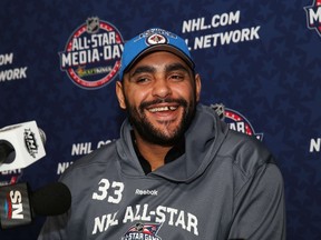 Dustin Byfuglien #33 of the Winnipeg Jets speaks during Media Availability for the 2015 NHL All-Star Weekend at the Nationwide Arena on January 23, 2015 in Columbus, Ohio