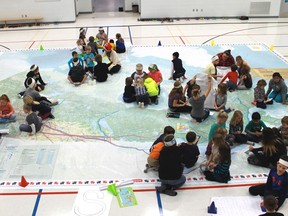 Rosedale Public School students explore Canadian geography through their recently acquired giant map of Canada. The map is on loan from Canadian Geography magazine and will remain at the school until Feb. 20. 
CARL HNATYSHYN/ QMI AGENCY