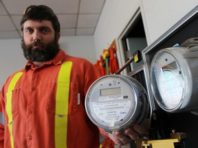 Tyler Gray, a meter technician with Bluewater Power, holds a Sensus Generation 3.2 remote disconnect meter next to a Sensus iConA meter being tested at Bluewater Power. The utility company has to switch out about 3,500 remote disconnect models with iConA replacements by March 31. There's a provincial concern the remote disconnect models could potentially arc and start fires. TYLER KULA/ THE OBSERVER/ QMI AGENCY