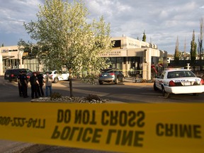 Edmonton Police Service officers investigate after an Acura MDX SUV crashed into a Ric's Grill near Rabbit Hill Road and 23 Avenue in Edmonton, Alta., on Sunday, May 19, 2013. A family was taken to hospital after the crash, which occurred around 8 p.m.. Ian Kucerak/Edmonton Sun