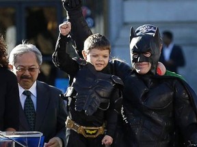 Miles Scott, dressed as Batkid, second from left, raises his arm next to Batman at a rally outside of City Hall with Mayor Ed Lee, left, and his mother Natalie Scott in San Francisco, Nov. 15, 2013


Miles Scott, dressed as Batkid, second from left, raises his arm next to Batman at a rally outside of City Hall with Mayor Ed Lee, left, and his mother Natalie Scott in San Francisco, Nov. 15, 2013.

Jeff Chiu/AP Photo