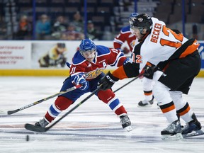 Luke Bertolucci (11) and Kyle Becker (12) battle during a WHL hockey game between the Edmonton Oil Kings and the Medicine Hat Tigers at Rexall Place in Edmonton on Tuesday, Sept. 30, 2014.  Ian Kucerak/Edmonton Sun/ QMI Agency