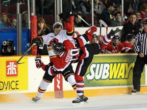 Ottawa 67's forward Jeremiah Addison takes a hit during the first period of Friday's game against the Belleville Bulls at TD Place. (Chris Hofley/Ottawa Sun)