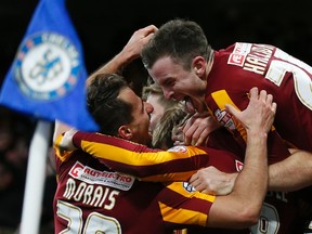 Bradford City's Filipe Morais (left) celebrates with teammate Andy Halliday after scoring against Chelsea during their FA Cup fourth round match at Stamford Bridge in London January 24, 2015. (REUTERS/Stefan Wermuth)
