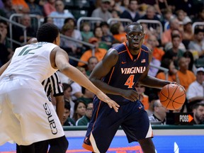 Virginia Cavaliers guard Marial Shayok (4) of Ottawa is pressured by Miami Hurricanes guard James Palmer (12) during an NCAA game Jan.3, 2015. (Steve Mitchell-USA TODAY Sports)