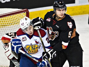 Edmonton's Edgars Kulda battles in front of the net with Calgary's Keegan Kanzig during the Edmonton Oil Kings' WHL hockey game against the Calgary Hitmen at Rexall Place in Edmonton, Alta., on Saturday, Jan. 24, 2015. Codie McLachlan/Edmonton Sun/QMI