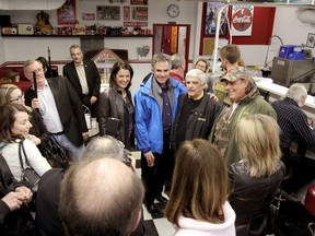 Former Wildrose leader and new PC MLA Danielle Smith and Alberta Premier Jim Prentice pose for a pictures with  High River residents at Evelyn's Memory Lane in High River, Alta., on Saturday January 24, 2015. Mike Drew/Calgary Sun/QMI Agency