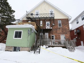 Police tape blocks access to the second-floor fire escape access to an apartment unit at the rear of 862 2nd Ave. W. in Owen Sound Friday. Police on Saturday identified apartment resident Lezleigh Hopkins, 28, as the victim of murder. (James Masters/Owen Sound/QMI)