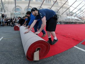 Crew members roll out the red carpet for tomorrow's Screen Actors Guild Awards at the Shrine Auditorium in Los Angeles, California January 24, 2015. The 21st Annual SAG Awards ceremony will take place Sunday at the Shrine Auditorium in Los Angeles. REUTERS/Jonathan Alcorn