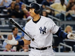 New York Yankees batter Alex Rodriguez reacts as he struck out against the Los Angeles Angels in the seventh inning of their MLB American League game at Yankee Stadium in New York, in this August 13, 2013 file photo. (REUTERS)