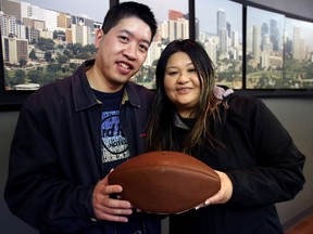 Doreen and Humphrey Woo pose for a photo at the Edmonton Sun on Sunday. The Edmonton couple won a local contest and will be attending the 49th Super Bowl in Phoenix, Arizona on Sunday. TREVOR ROBB/EDMONTON SUN/QMI AGENCY