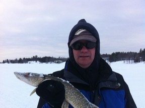 Sudbury's Bob Lamothe shows off a perfect eating-sized pike caught through the ice at a local lake.