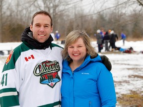 Sgt. Chris Downey and singer-songwriter Francine Leclair stand together at the CFB Trenton Pond Hockey Classic charity tournament in Batawa, Ont. Saturday, Jan. 24, 2015. Leclair wrote and recorded "I Soldier On," a song inspired by Downey's wounding in an explosion in Afghanistan. She's now donating the proceeds from the song to Soldier On, a charity aiding ill and injured troops. The hockey tournament also donated proceeds to the charity.