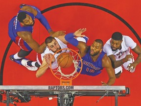 Members of the Raptors and PIstons fight for the ball under the basket during Sunday night's game at the ACC. (DAVE ABEL/Toronto Sun)