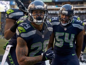 Free safety Earl Thomas #29 of the Seattle Seahawks celebrates with middle linebacker Bobby Wagner #54 of the Seattle Seahawks after Thomas made a play on a kick return during the third quarter of the game against the San Francisco 49ers at CenturyLink Field on December 14, 2014 in Seattle, Washington. (Otto Greule Jr/Getty Images/AFP)